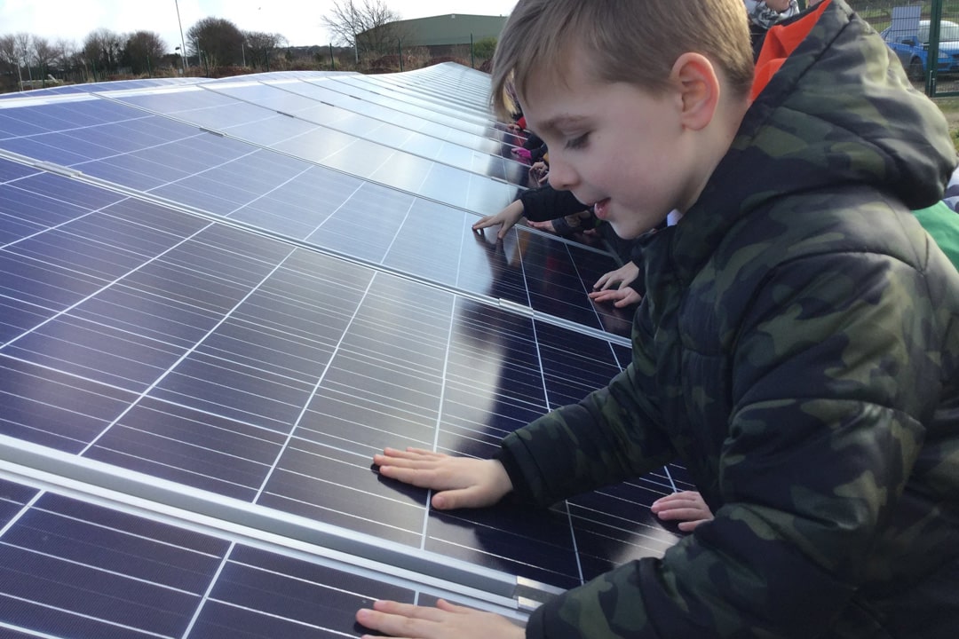 Local students experiencing an outdoor energy lesson at Plymouth's community solar farm in Ernesettle